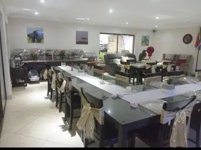 a large room with tables and chairs in a store at Mountvista Guesthouse in Pretoria