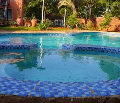 a large swimming pool with blue water at Mountvista Guesthouse in Pretoria