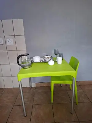a small green table with dishes on it at comfort zone in Kempton Park