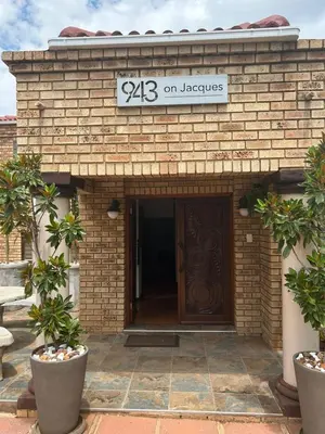 a brick building with a door with a sign on it at 943 on Jacques in Pretoria