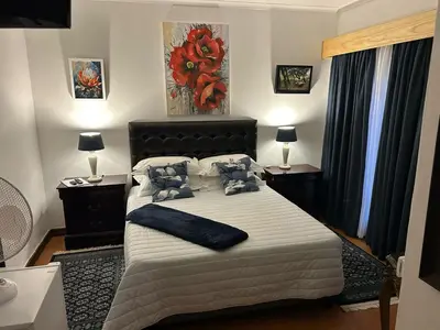 a bedroom with a large bed with two tables and two lamps at 943 on Jacques in Pretoria