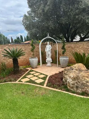 a statue of a woman in a garden at 943 on Jacques in Pretoria