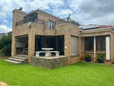 a brick house with a bench in the yard at 943 on Jacques in Pretoria