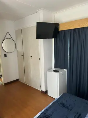 a bedroom with a bed and a television on the wall at 943 on Jacques in Pretoria