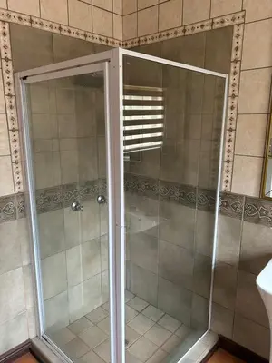 a shower with a glass door in a bathroom at 943 on Jacques in Pretoria