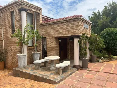 a brick house with a bench and a table at 943 on Jacques in Pretoria