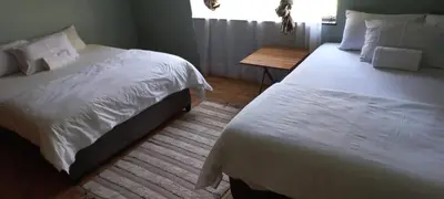 a hotel room with two beds and a window at Majestic Guest House in Mokopane