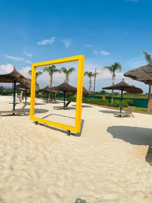 a yellow mirror sitting on a beach with umbrellas at 1 bedroom- The Blyde by Given in Pretoria