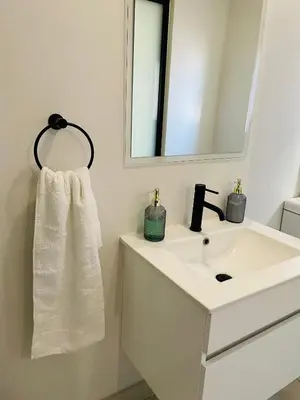 a bathroom with a white sink and a mirror at 1 bedroom- The Blyde by Given in Pretoria