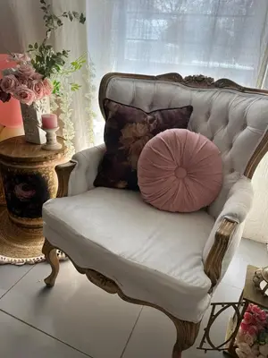 a pink pillow sitting on a white chair at casa bella in Hartbeespoort