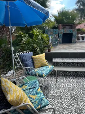 two chairs and an umbrella on a patio at casa bella in Hartbeespoort