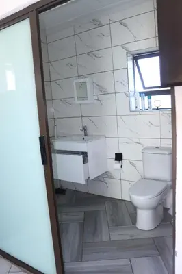 a bathroom with a toilet and a sink at Alldays Sunset Lodge in Alldays