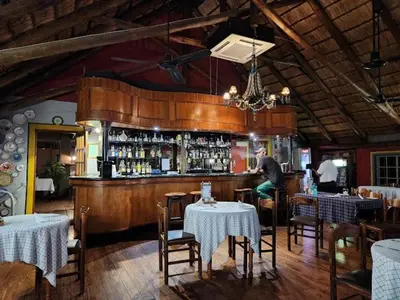a man sitting at a bar in a restaurant at The Gateway Inn in Louis Trichardt