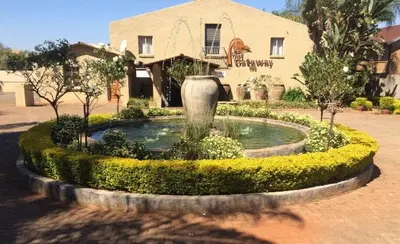 a large fountain in front of a building at The Gateway Inn in Louis Trichardt