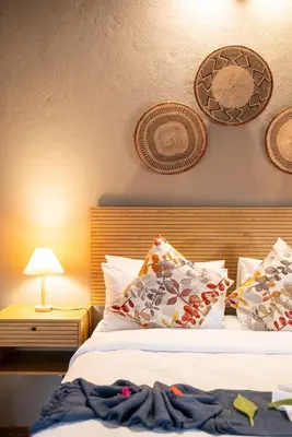 a bedroom with a bed with pillows on it at Ngoma Bush Lodge in Hoedspruit