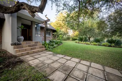 a house with a walkway leading to a yard at Ngoma Bush Lodge in Hoedspruit