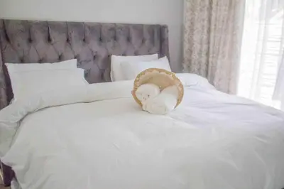 a stuffed animal sitting on top of a bed at Serenity in Hartbeespoort