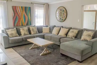 a living room with a couch and a coffee table at Serenity in Hartbeespoort
