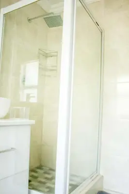a shower with a glass door in a bathroom at Serenity in Hartbeespoort