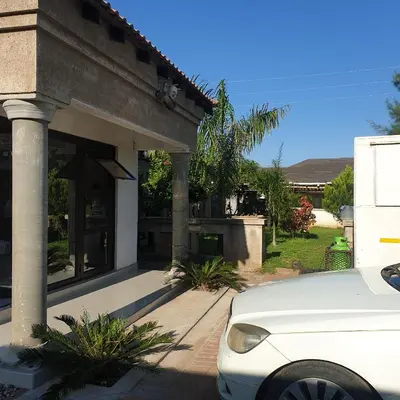 a white car parked in front of a house at Muhle Guesthouse in Giyani