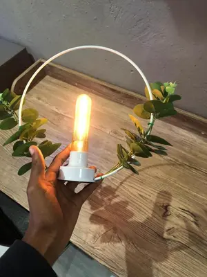 a person holding a light on top of a table at Muhle Guesthouse in Giyani
