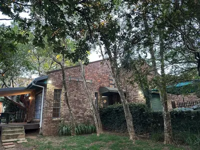 a brick house with trees in front of it at Three on Taurus in Nelspruit