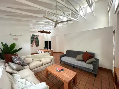 a living room with two couches and a table at Three on Taurus in Nelspruit