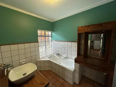 a bathroom with a sink and a bath tub at Three on Taurus in Nelspruit