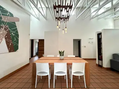 a dining room with a table and white chairs at Three on Taurus in Nelspruit