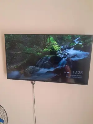 a flat screen tv with a picture of a creek at Menlyn Place Cityscape in Pretoria