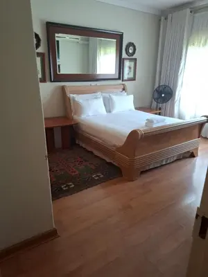 a bedroom with a bed with a mirror on the wall at The Adress in Midrand