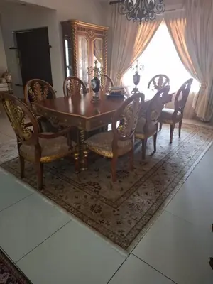 a dining room with a wooden table and chairs at The Adress in Midrand