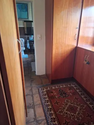 a hallway with a door and a rug on the floor at The Adress in Midrand