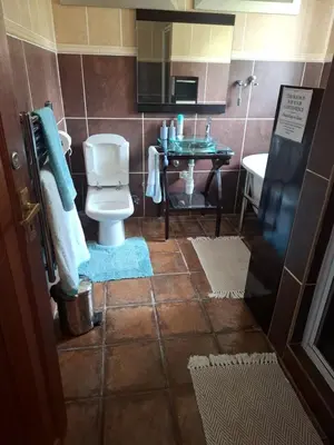 a bathroom with a toilet and a sink at The Adress in Midrand