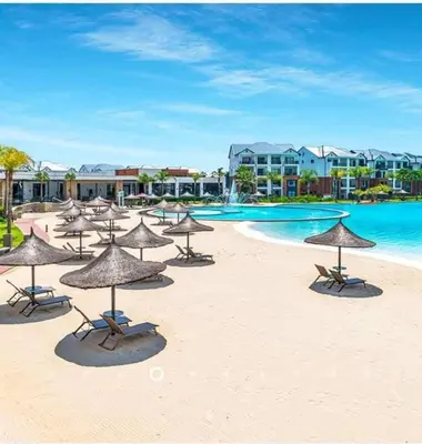 a beach with chairs and umbrellas on the sand at Kayalako at The Blyde 2 in Pretoria