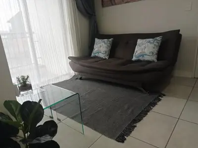 a couch in a living room with a glass table at Kayalako at The Blyde 2 in Pretoria