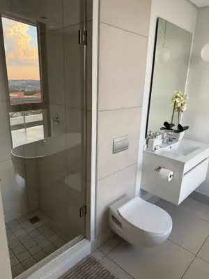 a bathroom with a toilet and a shower and a sink at Cassini Dreaming in Northdene