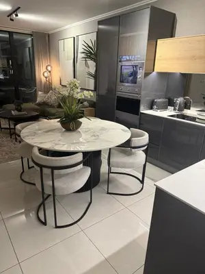 a kitchen with a table and chairs in a kitchen at Cassini Dreaming in Northdene