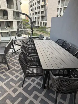 a wooden table and chairs on a balcony at Cassini Dreaming in Northdene