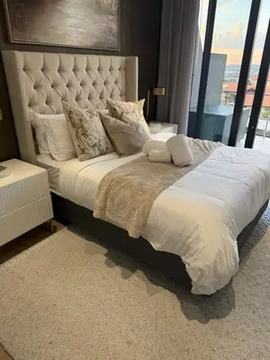 a large bed in a bedroom with a large window at Cassini Dreaming in Northdene