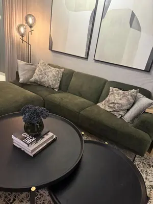 a living room with a green couch and a table at Cassini Dreaming in Northdene