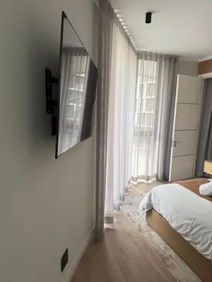 a bedroom with a bed and a large window at Cassini Dreaming in Northdene
