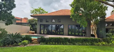 a house with a swimming pool and a yard at Luxury oasis retreat in Hartbeespoort