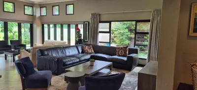 a living room with a couch and a table at Luxury oasis retreat in Hartbeespoort