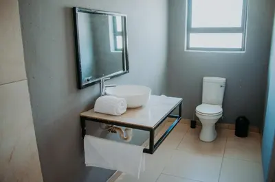 a bathroom with a sink and a toilet at Karabelo guesthouse in Groblersdal
