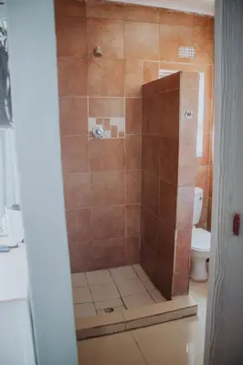 a shower stall with a toilet in a bathroom at Karabelo guesthouse in Groblersdal