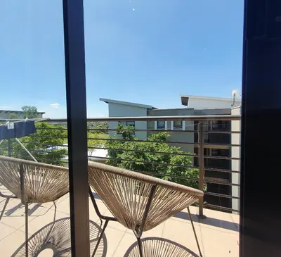 a view of a balcony with two benches at Studio Apartment near Dainfern Golf Club I Montecasino I Indaba Hotel in Sandton