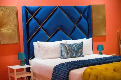 a bed with a blue headboard in a room at Kneizenberg Boutique Lodge & Spa in Louis Trichardt
