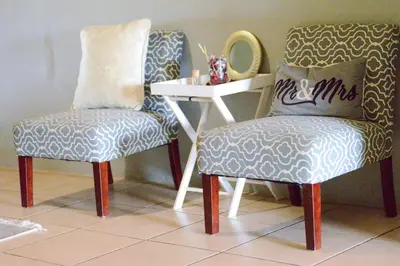 two chairs sitting next to a table with a mirror at Kneizenberg Boutique Lodge & Spa in Louis Trichardt