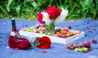 a box of fruit and a bottle of wine and flowers at Kneizenberg Boutique Lodge & Spa in Louis Trichardt
